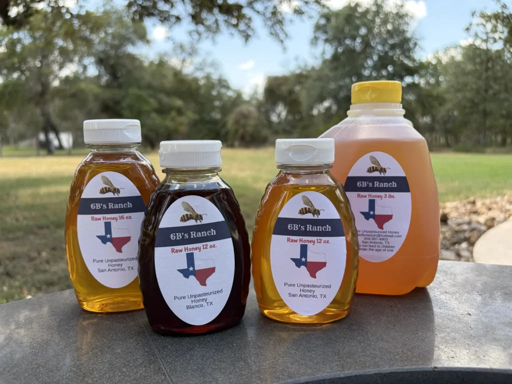 6B's Ranch raw honey lineup showing the lighter San Antonio honey beside the darker Blanco honey, in 16 oz, 12 oz and 3 lbs sizes