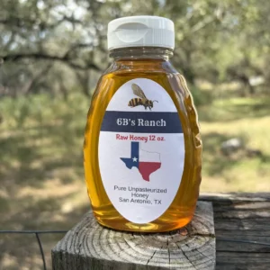6B's Ranch 12 oz San Antonio raw honey, light golden, on a fence post
